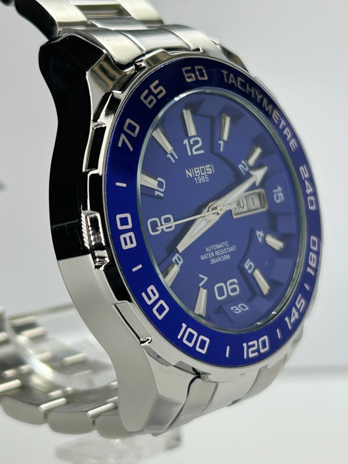 Nibosi NI2596 Mens Automatic 42MM Day/Date Silver Tone Blue Dial Exhibition Back