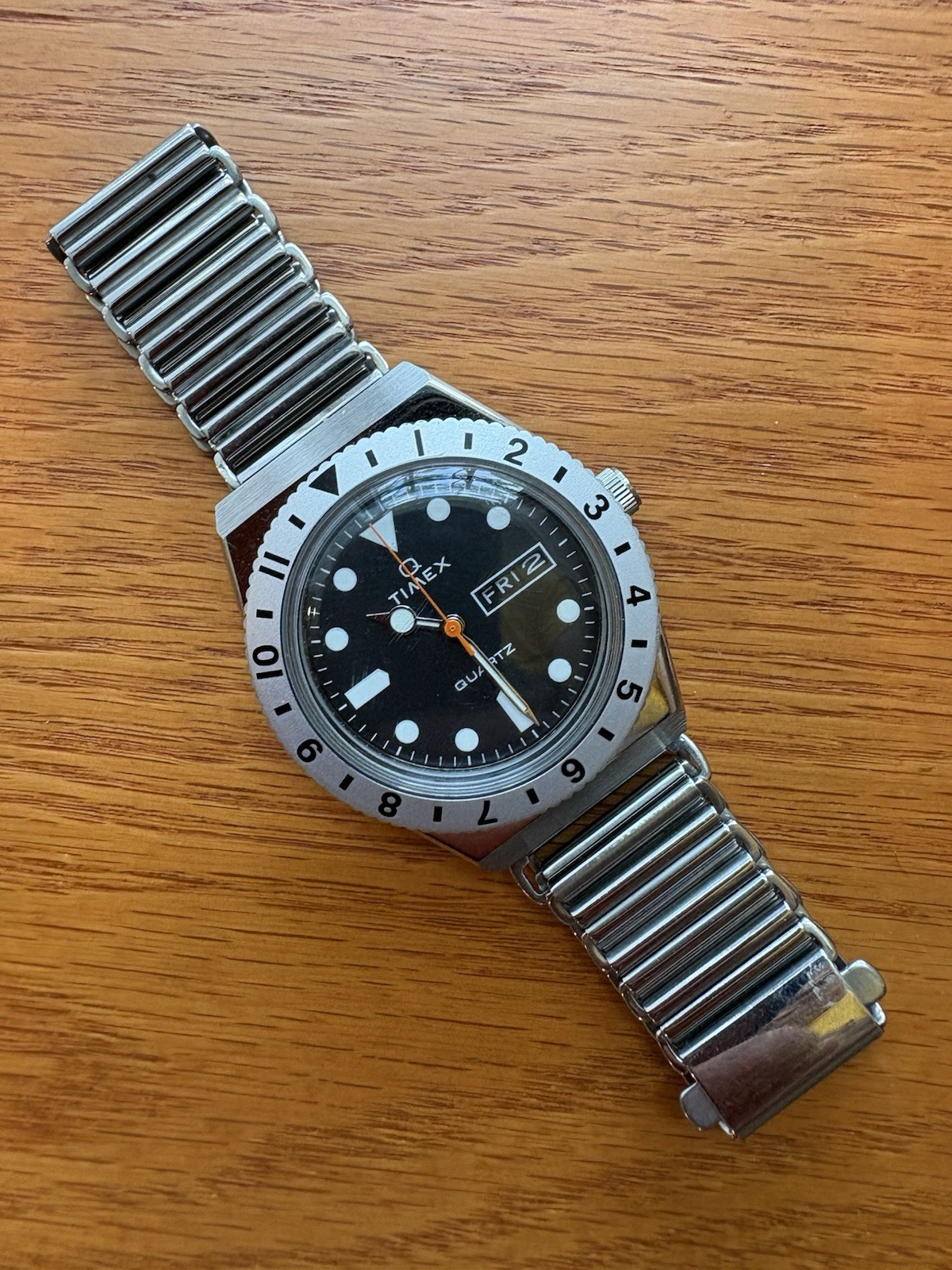 Timex Q Reissue, 12-hr dual-time bidirectional bezel, Bonklip-style bracelet.
