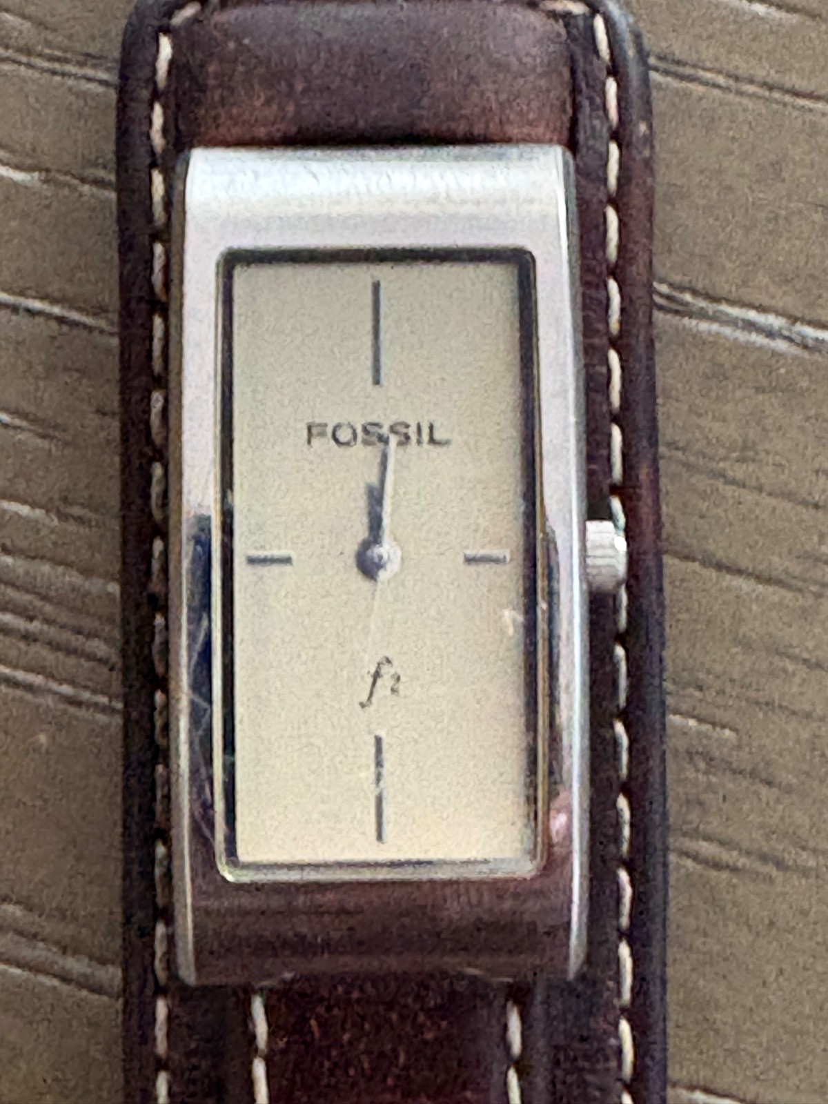 womens vintage fossil watch with silver rectangular face and brown leather strap
