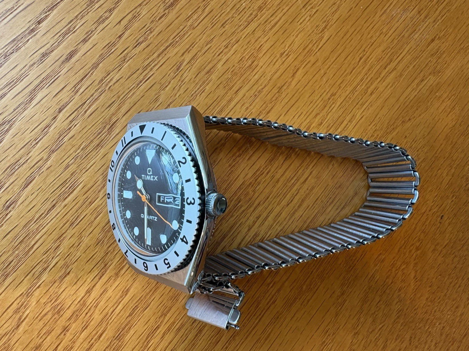 Timex Q Reissue, 12-hr dual-time bidirectional bezel, Bonklip-style bracelet.