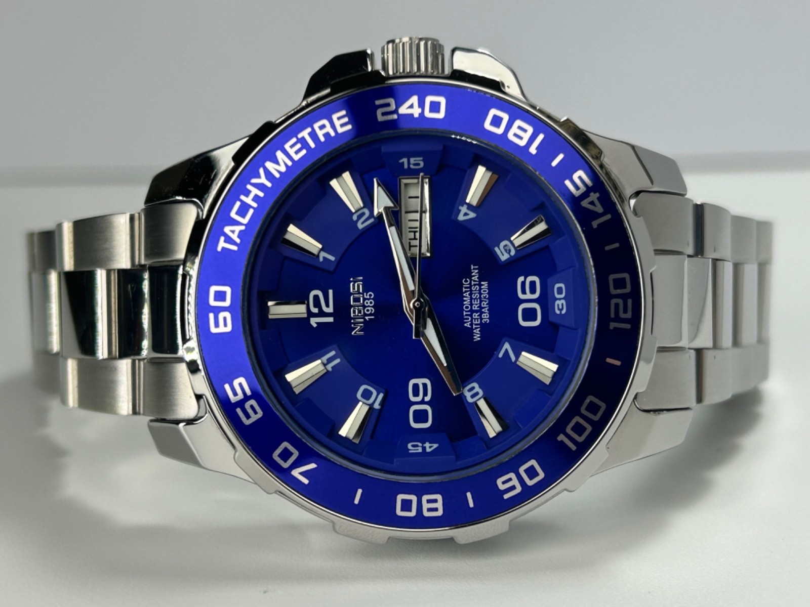 Nibosi NI2596 Mens Automatic 42MM Day/Date Silver Tone Blue Dial Exhibition Back
