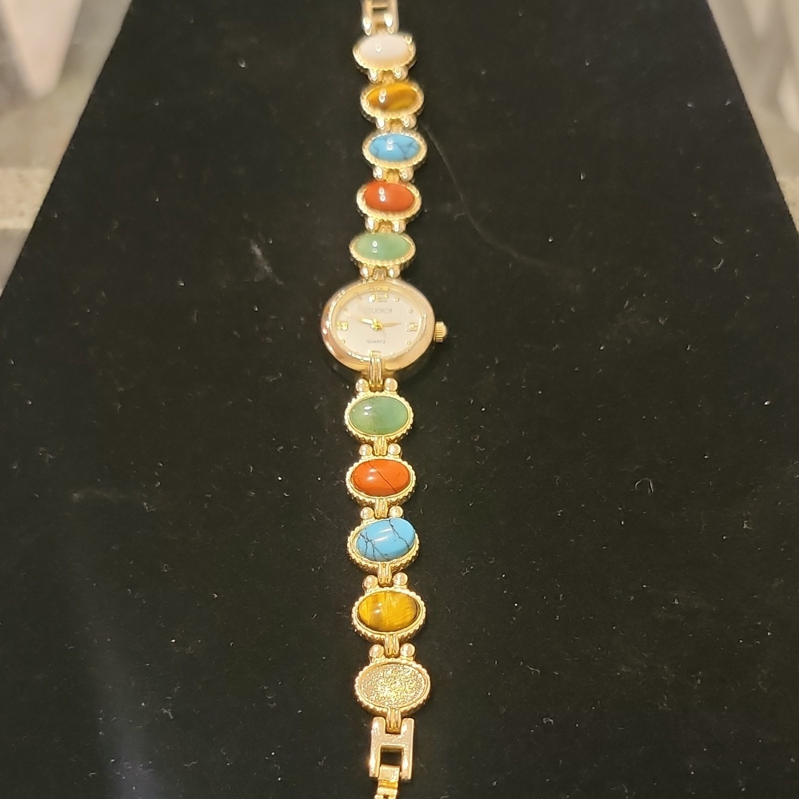 Studio Women’s Gem Stones Gold Tone Bracelet Watch Multicolor Stones