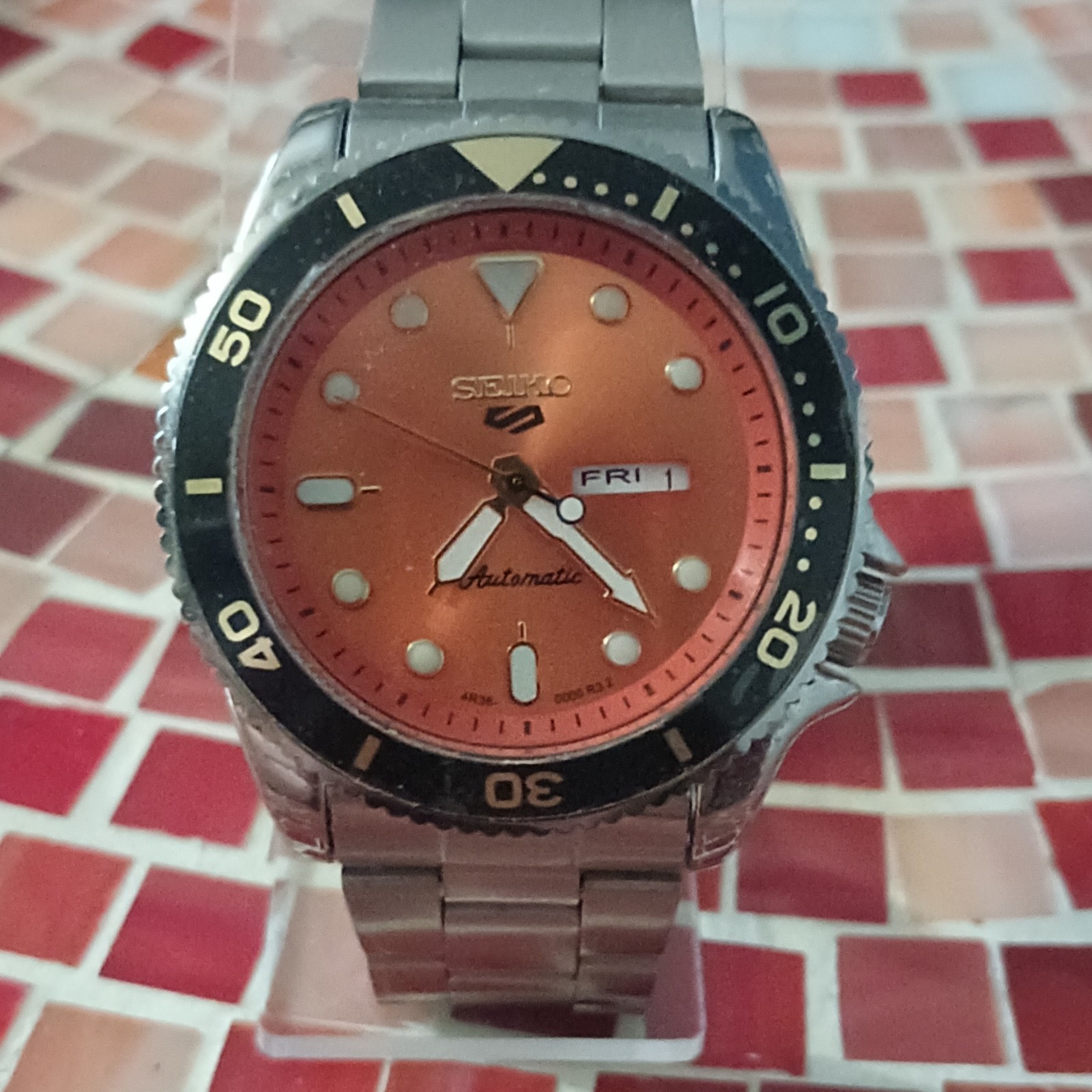 Seiko 5 Men’s Automatic Diver Wristwatch Orange Dial Day/Date Black Bezel