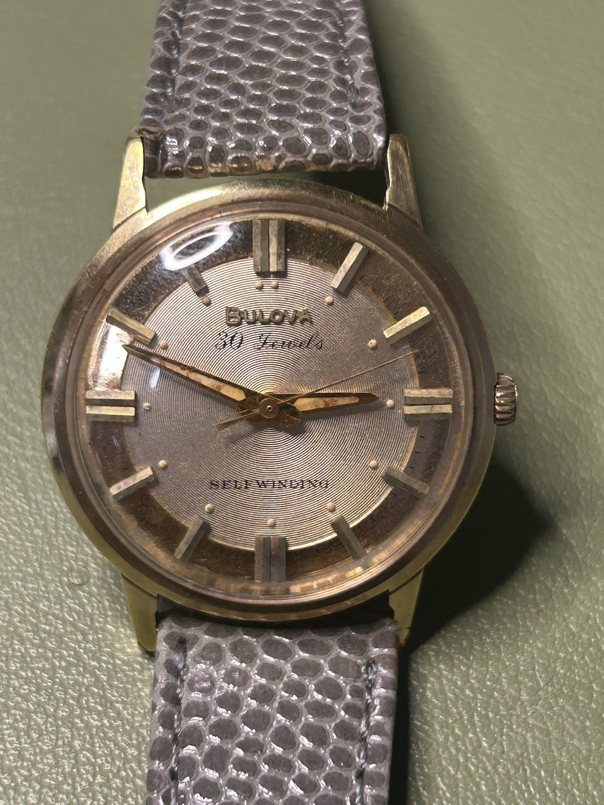 Bulova 30 Jewels Self-Winding Gold Tone Silver Dial Gray Leather Strap