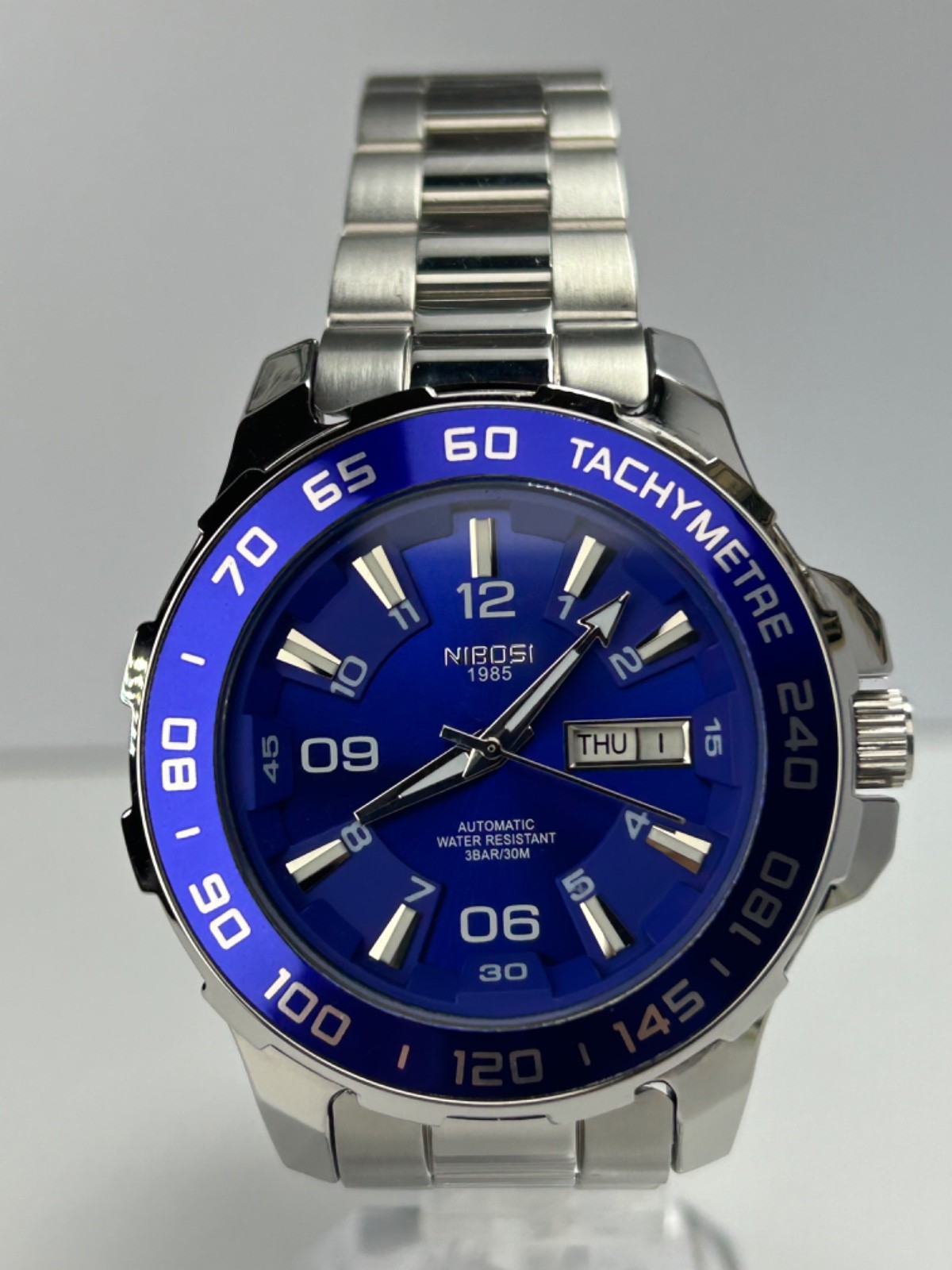 Nibosi NI2596 Mens Automatic 42MM Day/Date Silver Tone Blue Dial Exhibition Back