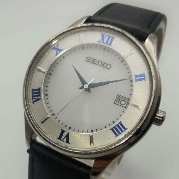 SEIKO V157-0CZ0 Mens Solar Titanium Roman Date Watch White Blue Dial
