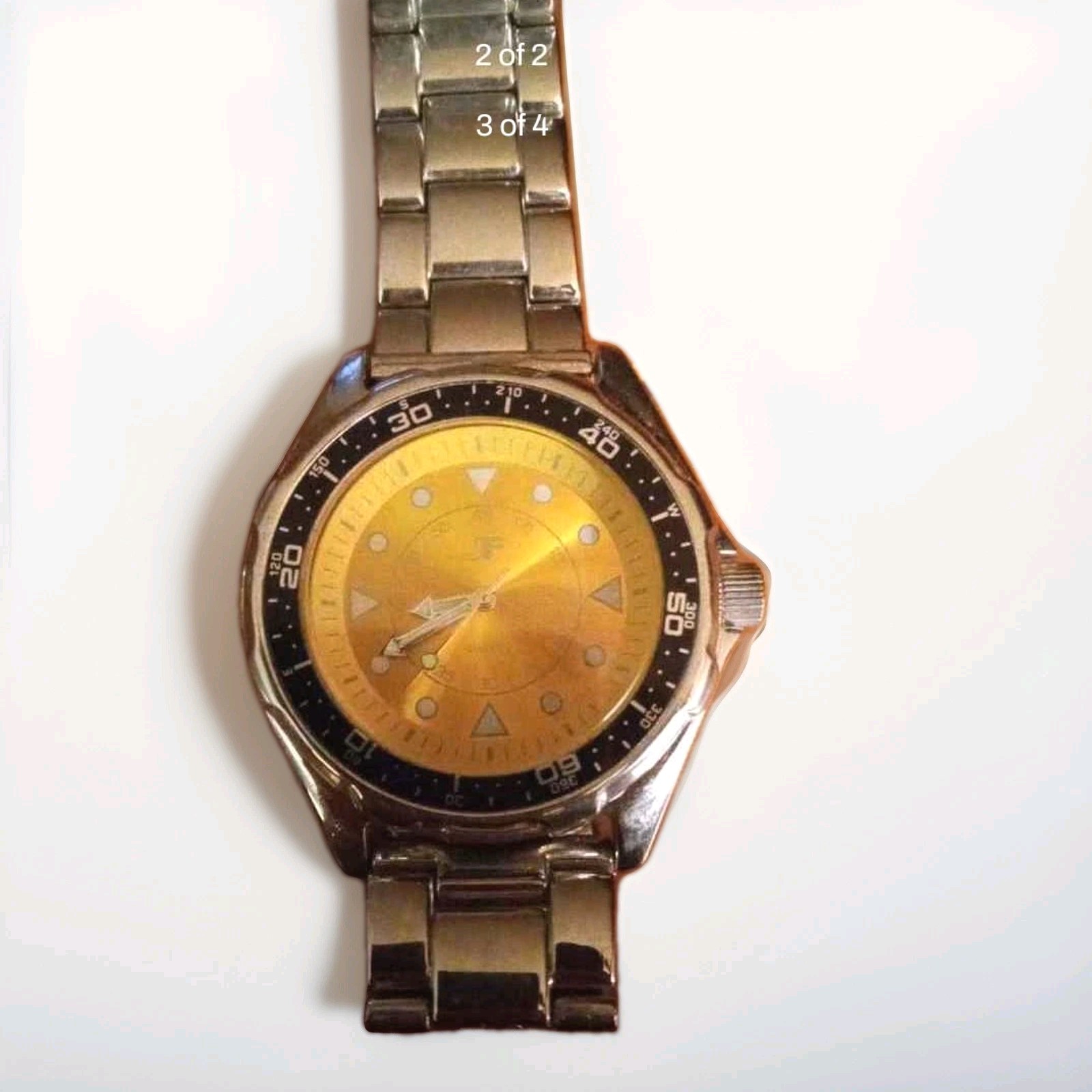 JF Quartz Analog Wristwatch Gold Dial Black Fixed Bezel Silver Bracelet