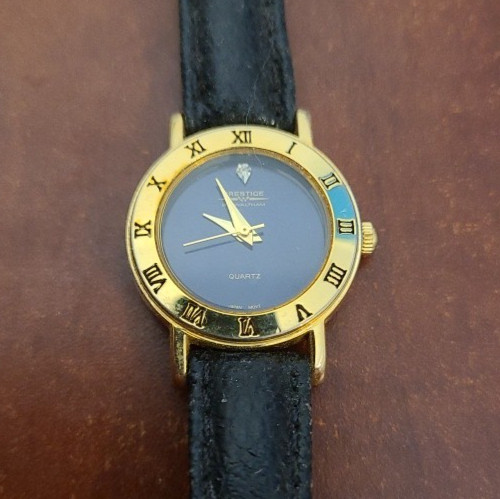 PRESTIGE by WALTHAM QUARTZ WATCH. DIAMOND DIAL WITH GOLD TONE