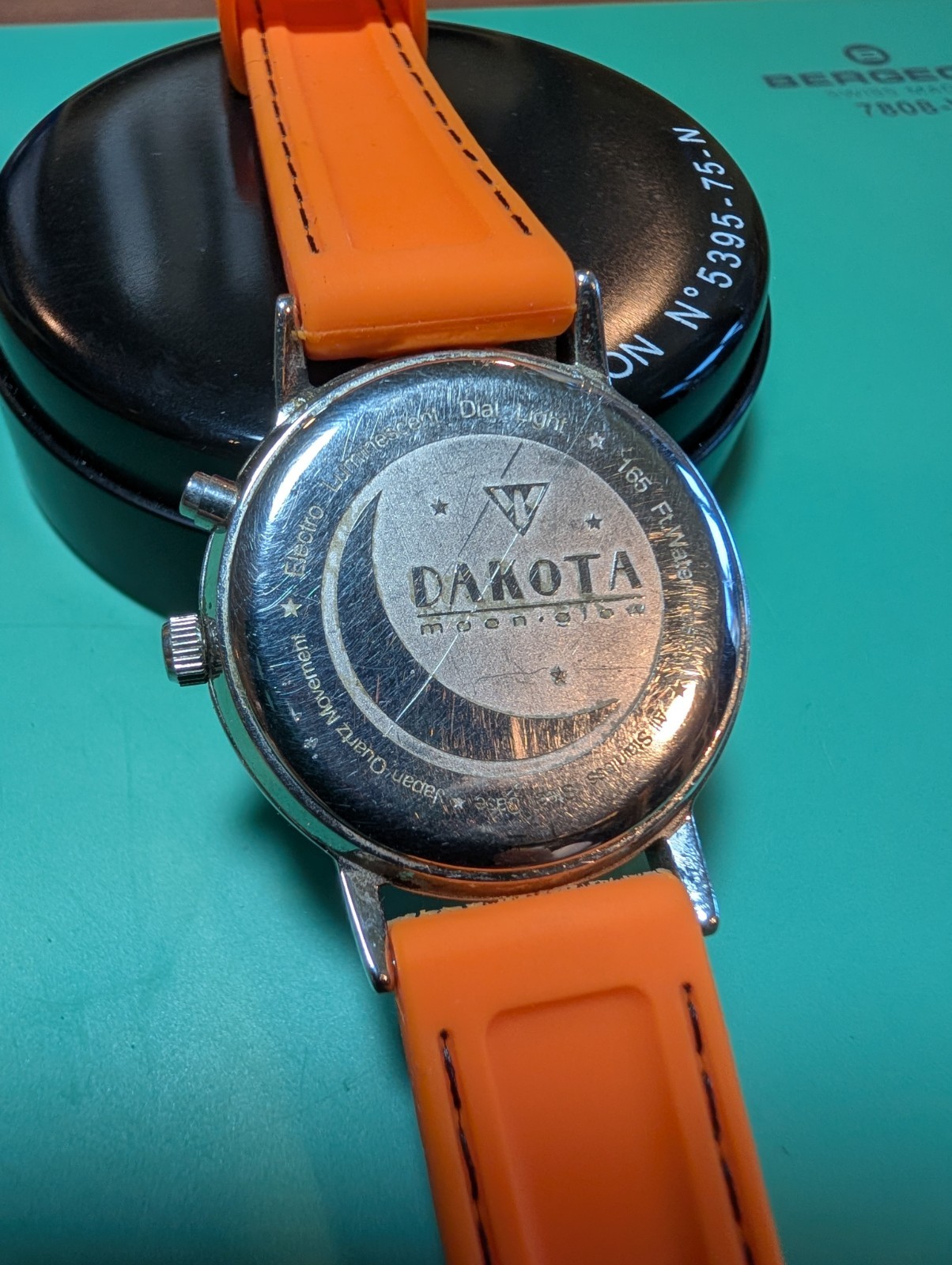 Dakota Moon-Glow Quartz Analog Watch Date Luminous White Dial Orange Strap