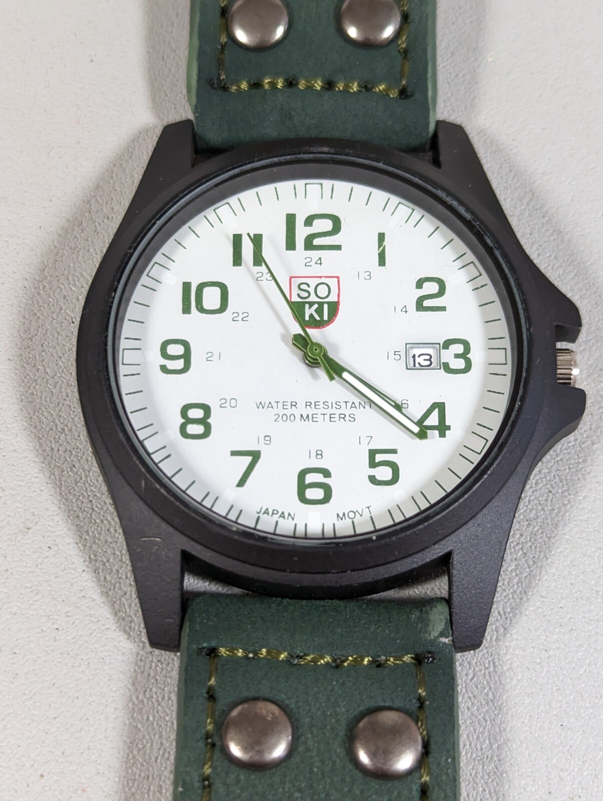 Soki White Dial Date Indicator Black Round Case Green Faux Leather Band Watch