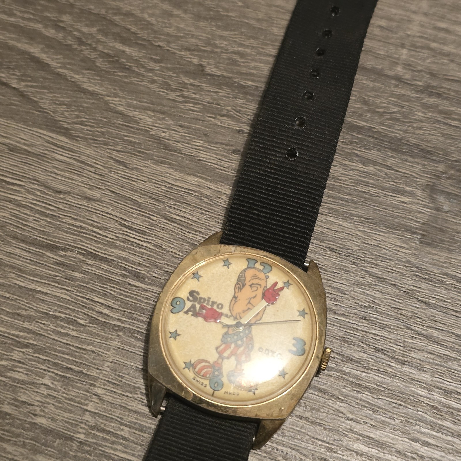 Spiro Agnew Quartz Analog Wristwatch Black Nylon Strap Gold Metal Case 12Hr