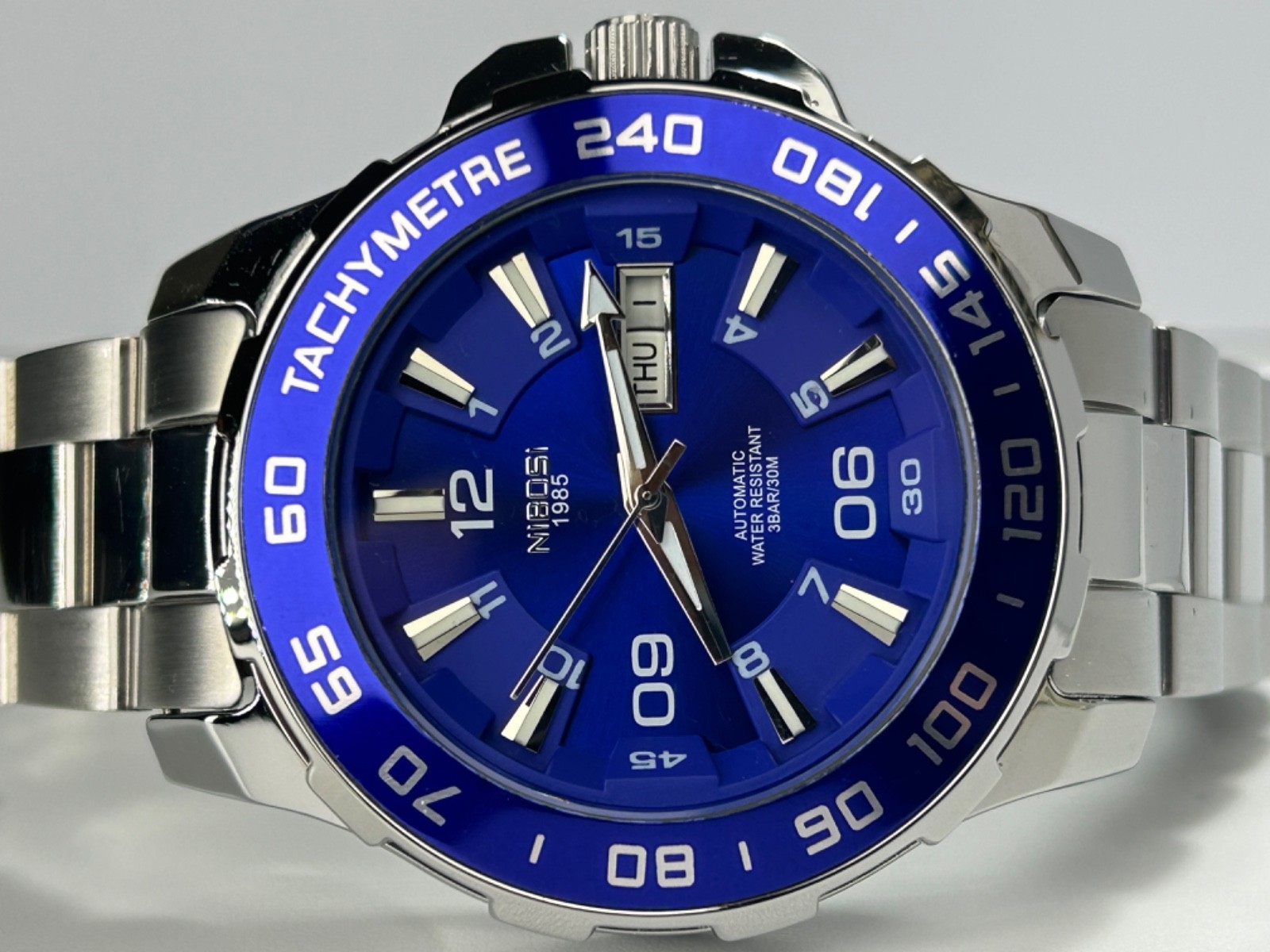 Nibosi NI2596 Mens Automatic 42MM Day/Date Silver Tone Blue Dial Exhibition Back