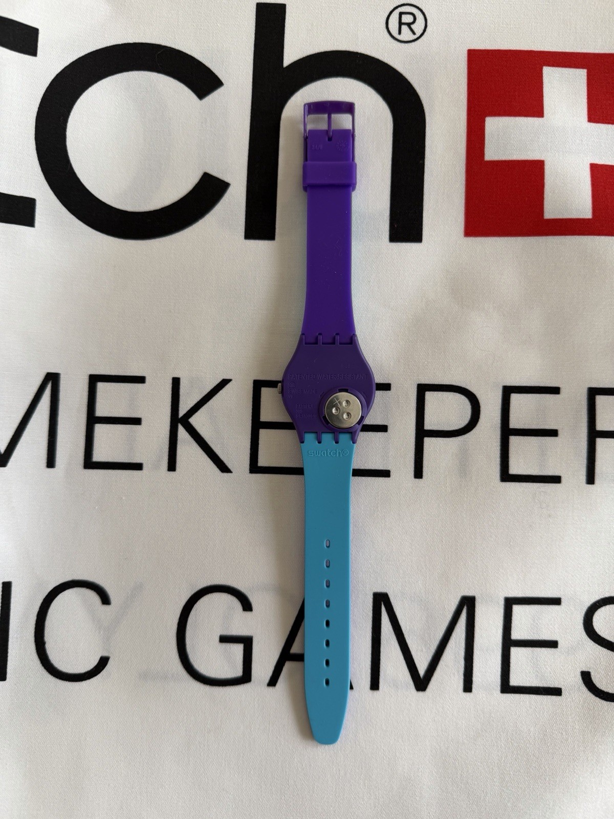 Swatch GV128 Polymer Watch – Turquoise Dial& Purple Strap – New in Box