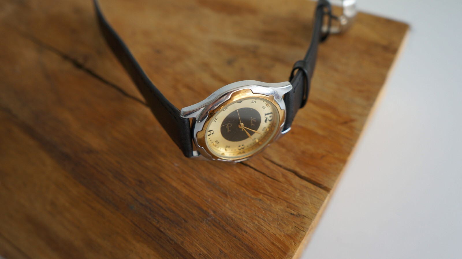 LUCH quartz wristwatch with two-tone metal case and pearl sheen dial