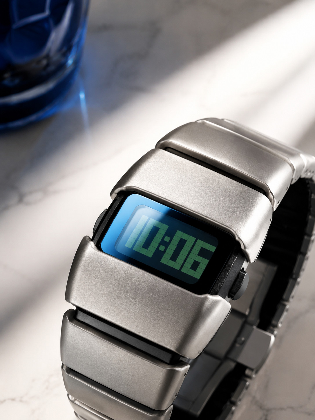 Sleek silver metal digital watch with retro futuristic style.