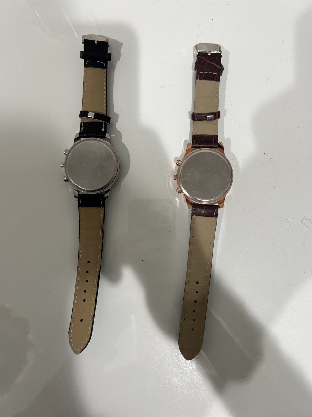 Two Men’s wristwatches. Blue Migeer W Black Band. Black And Rose Gold Geneva