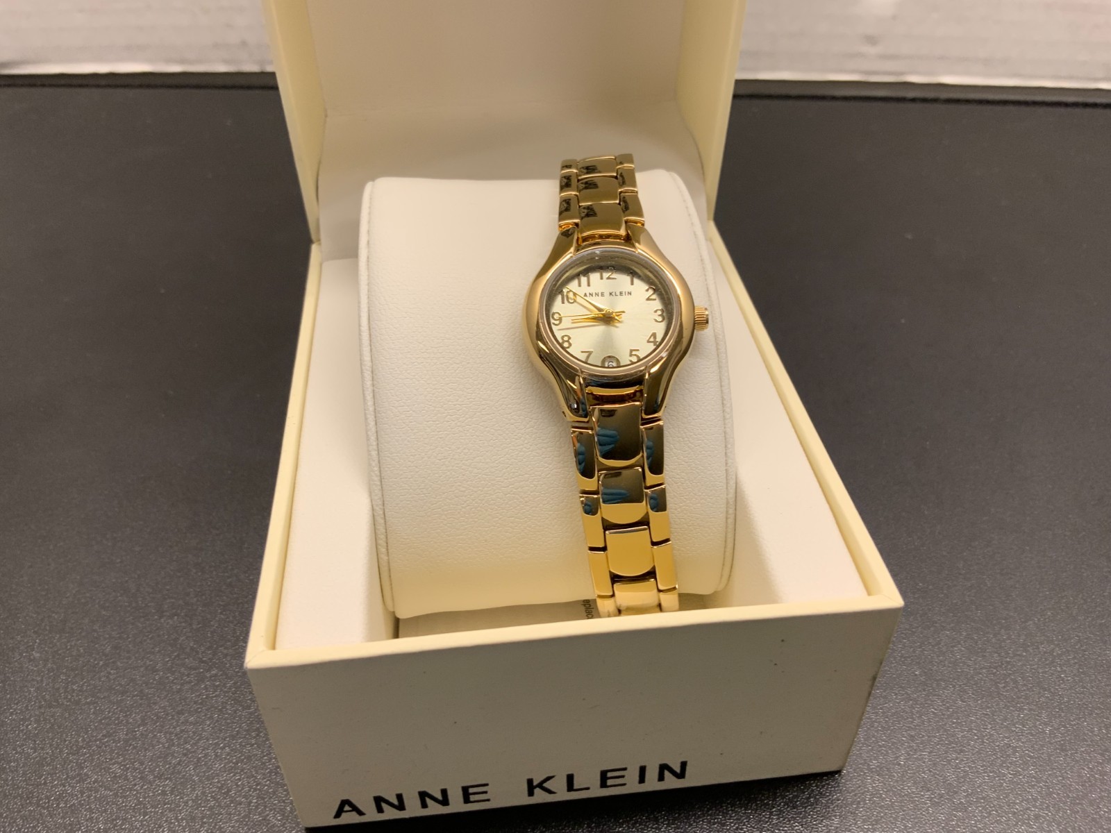 Anne Klein 10-6776G Women’s Round Analog Gold Tone Date Dial Dress Watch