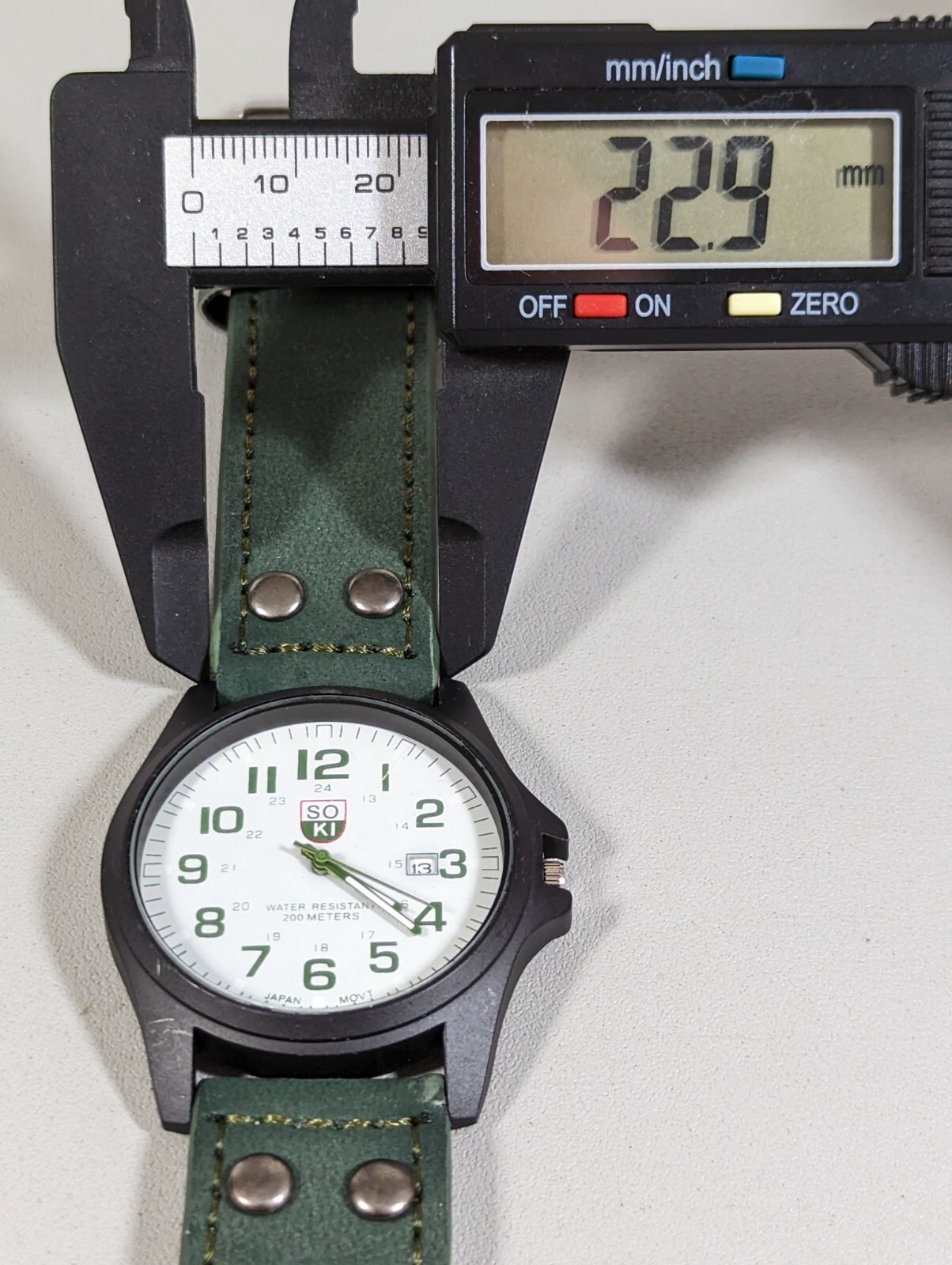 Soki White Dial Date Indicator Black Round Case Green Faux Leather Band Watch