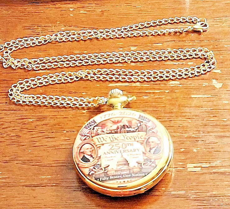 Gold tone comememorative pocket watch titled Anniversary We the People